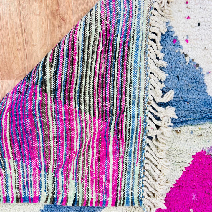 Vintage Moroccan wool rug with abstract Berber geometric pattern in pink, ivory, blue, and black
