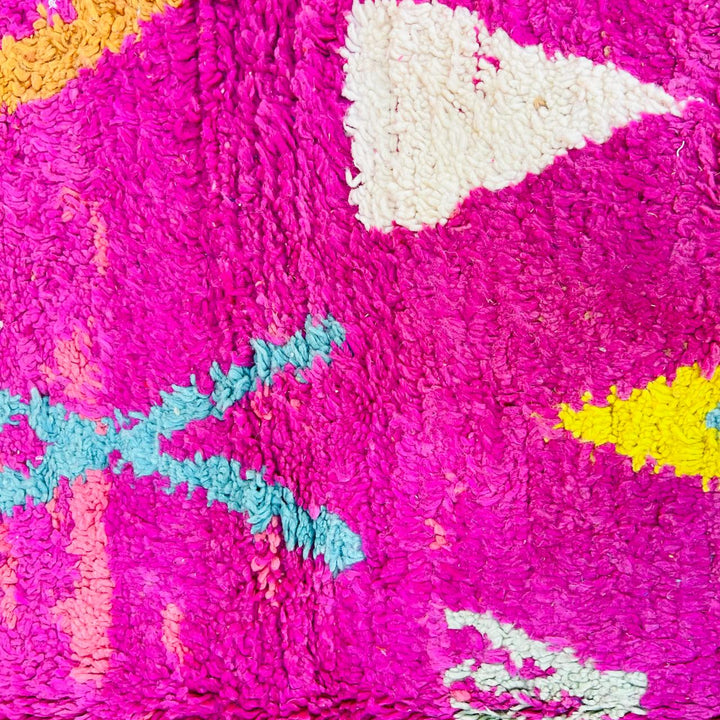 Vintage Moroccan wool rug with pink Berber tribal symbols, handmade in Morocco