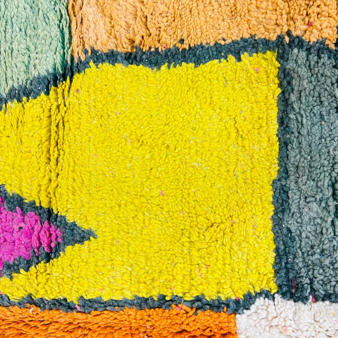 Vintage Moroccan wool rug with colorful geometric Berber pattern in pink yellow green and cream – handmade in Morocco