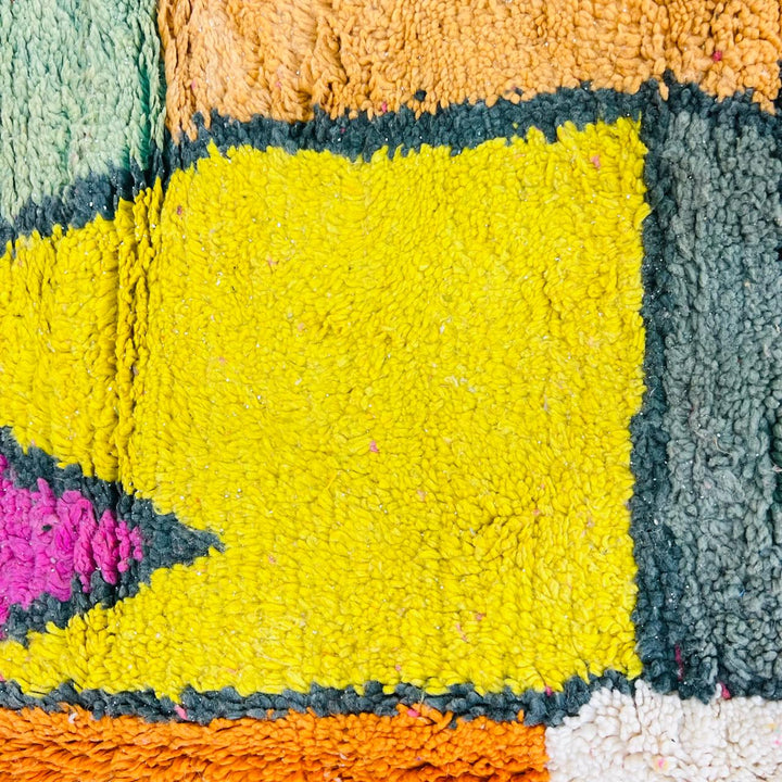 Vintage Moroccan wool rug with colorful geometric Berber pattern in pink yellow green and cream – handmade in Morocco