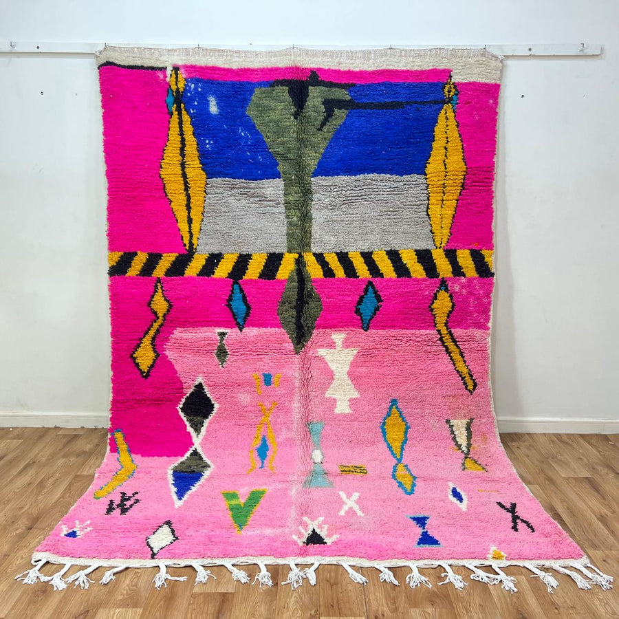 Vintage Moroccan wool rug with pink background and colorful Berber symbols, handmade in Morocco
