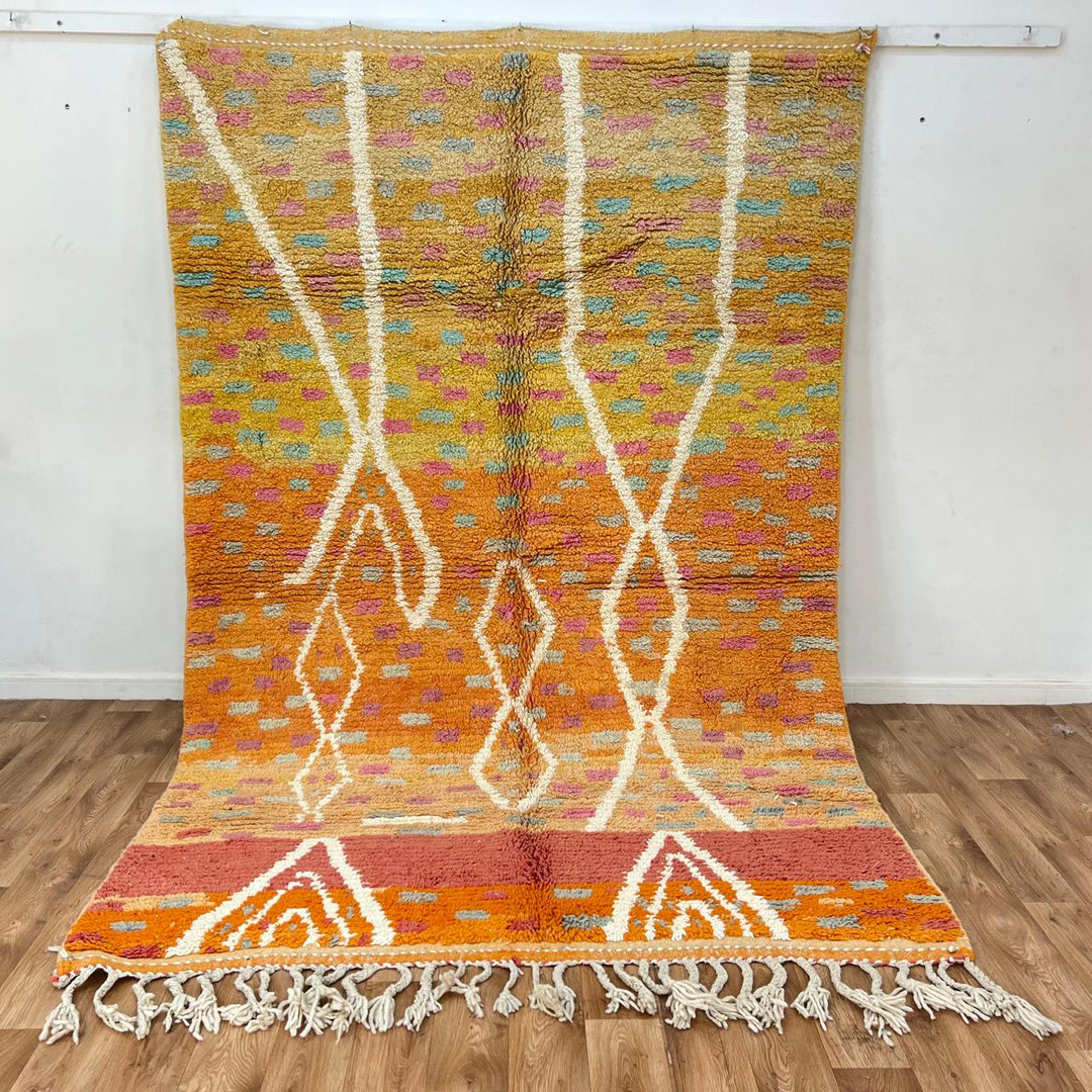 Vintage Moroccan wool rug in orange tones with white Berber diamond patterns, handmade in Morocco