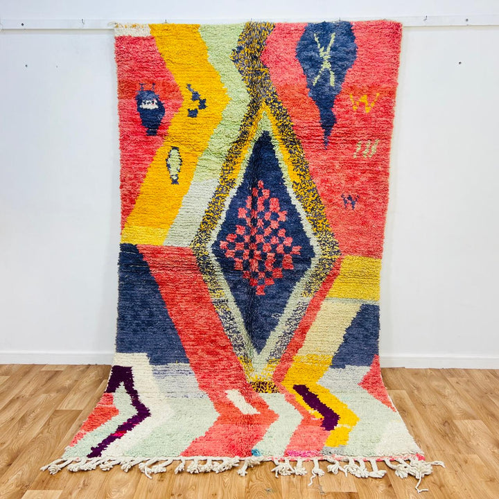 Vintage Moroccan wool rug with abstract Berber geometric design in coral pink, mustard yellow, navy and cream, handmade in Morocco