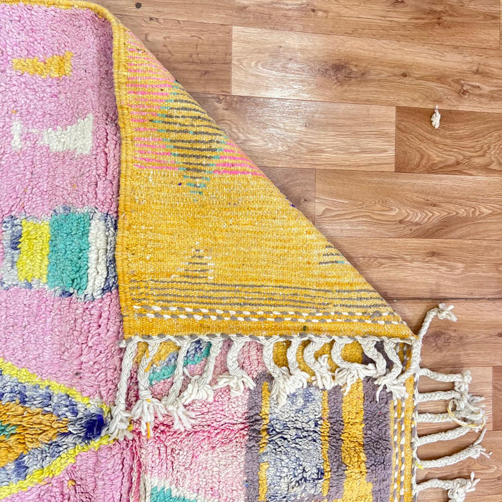 Vintage Moroccan wool rug with colorful Berber geometric pattern on pink background, 260x161 cm