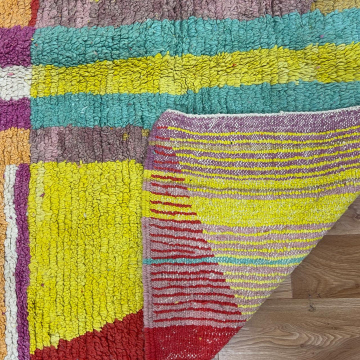 Vintage Moroccan wool rug 8.53x5.84 ft, handmade Berber shag rug with colorful striped pattern and central geometric design in yellow, pink, turquoise and red tones