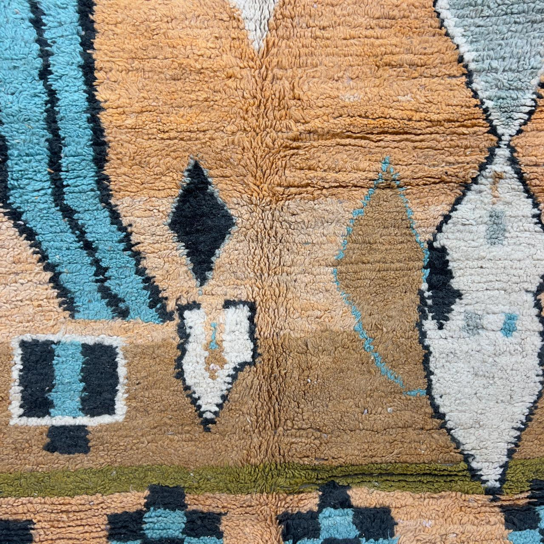 Vintage Moroccan wool rug with abstract geometric patterns in beige, mustard, and turquoise tones, handmade Berber carpet
