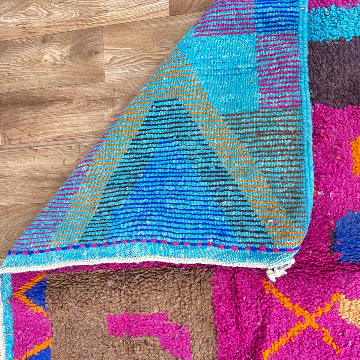 Vintage Moroccan wool rug with colorful Berber geometric patterns in pink, blue, and orange