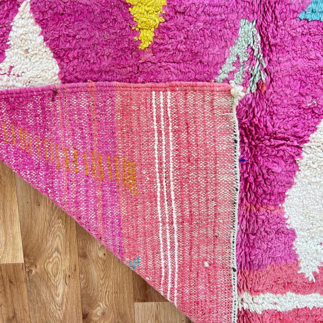 Vintage Moroccan wool rug in pink and yellow tones with abstract Berber geometric patterns, handmade in Morocco