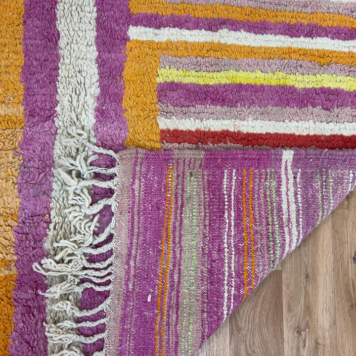 Vintage Moroccan wool rug 8.53x5.84 ft, handmade Berber shag rug with colorful striped pattern and central geometric design in yellow, pink, turquoise and red tones