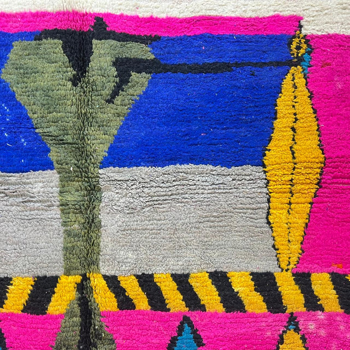 Vintage Moroccan wool rug with pink background and colorful Berber symbols, handmade in Morocco