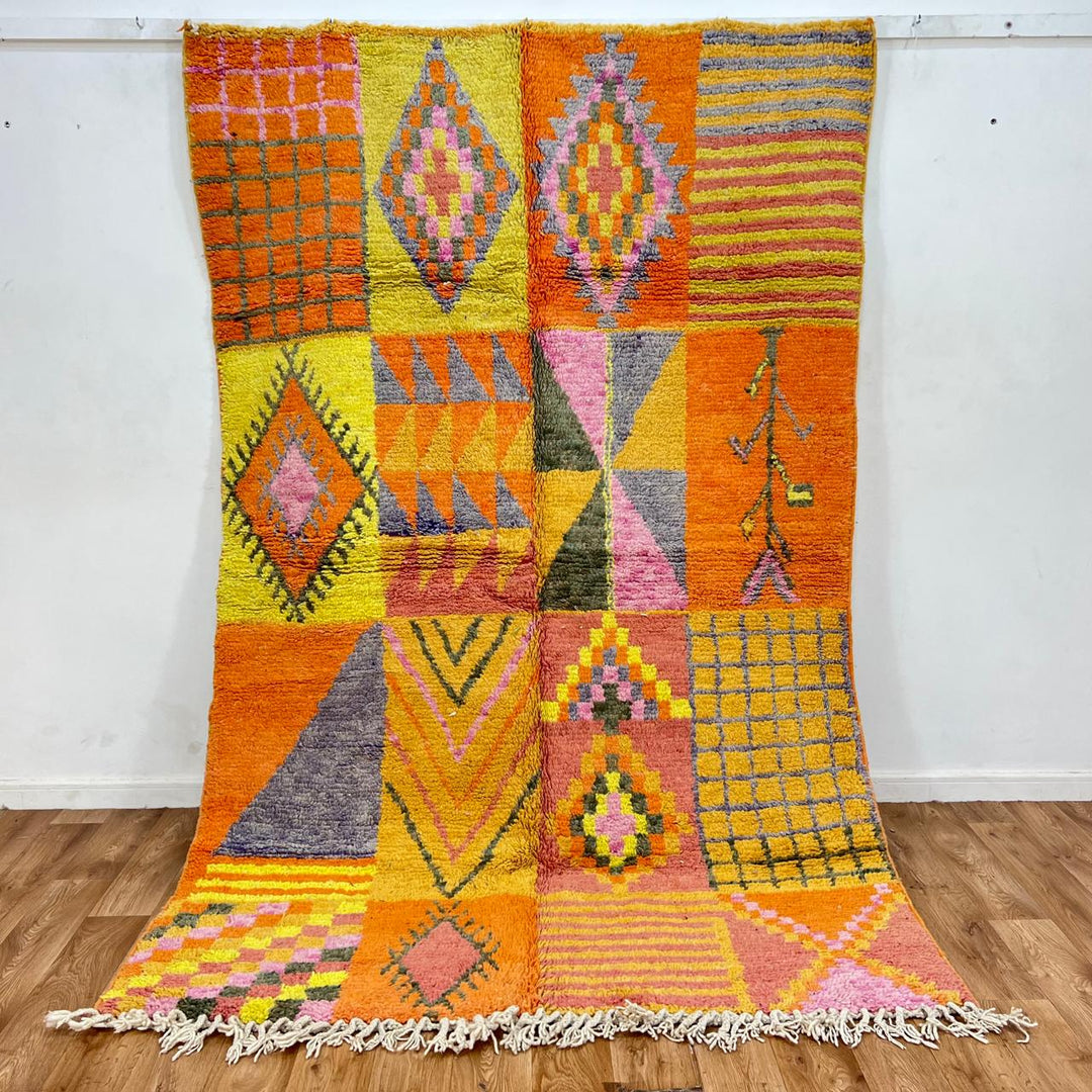 Vintage Moroccan wool rug with colorful geometric patchwork pattern in orange, yellow and pink
