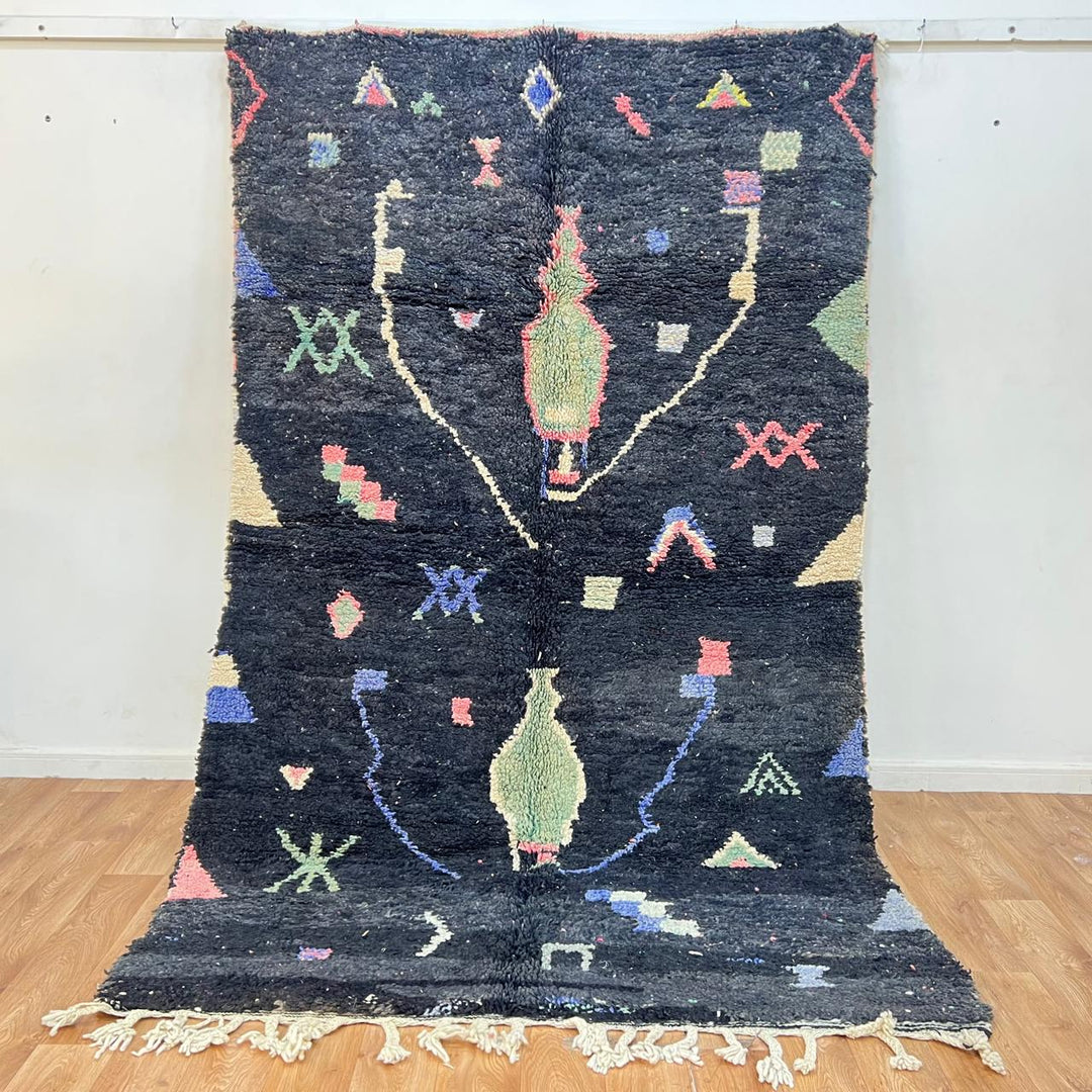 Black vintage Moroccan Berber rug with colorful tribal symbols handwoven in natural wool