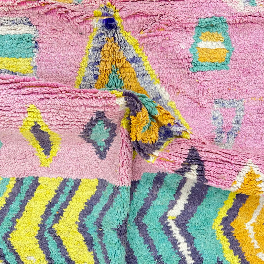 Vintage Moroccan wool rug with colorful Berber geometric pattern on pink background, 260x161 cm