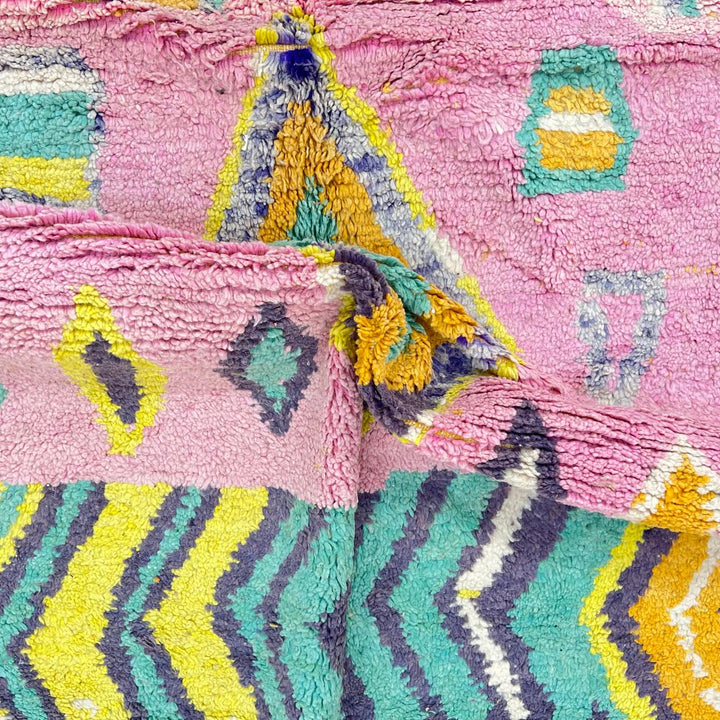 Vintage Moroccan wool rug with colorful Berber geometric pattern on pink background, 260x161 cm