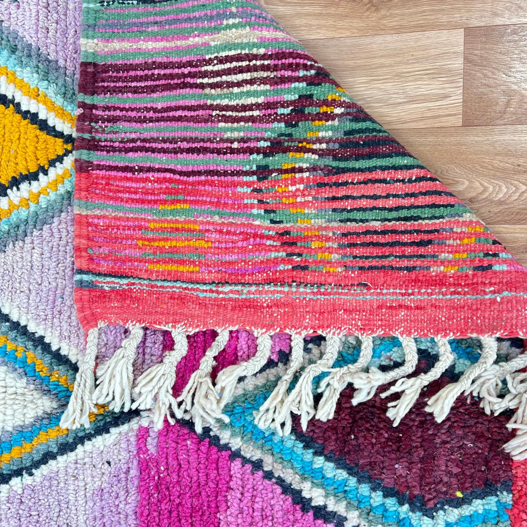 Vintage Moroccan wool rug with purple background and colorful diamond Berber patterns, handmade in Morocco