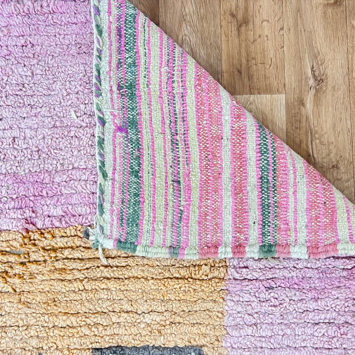 Vintage Moroccan wool rug with pink tones and abstract Berber symbols, handmade in Morocco