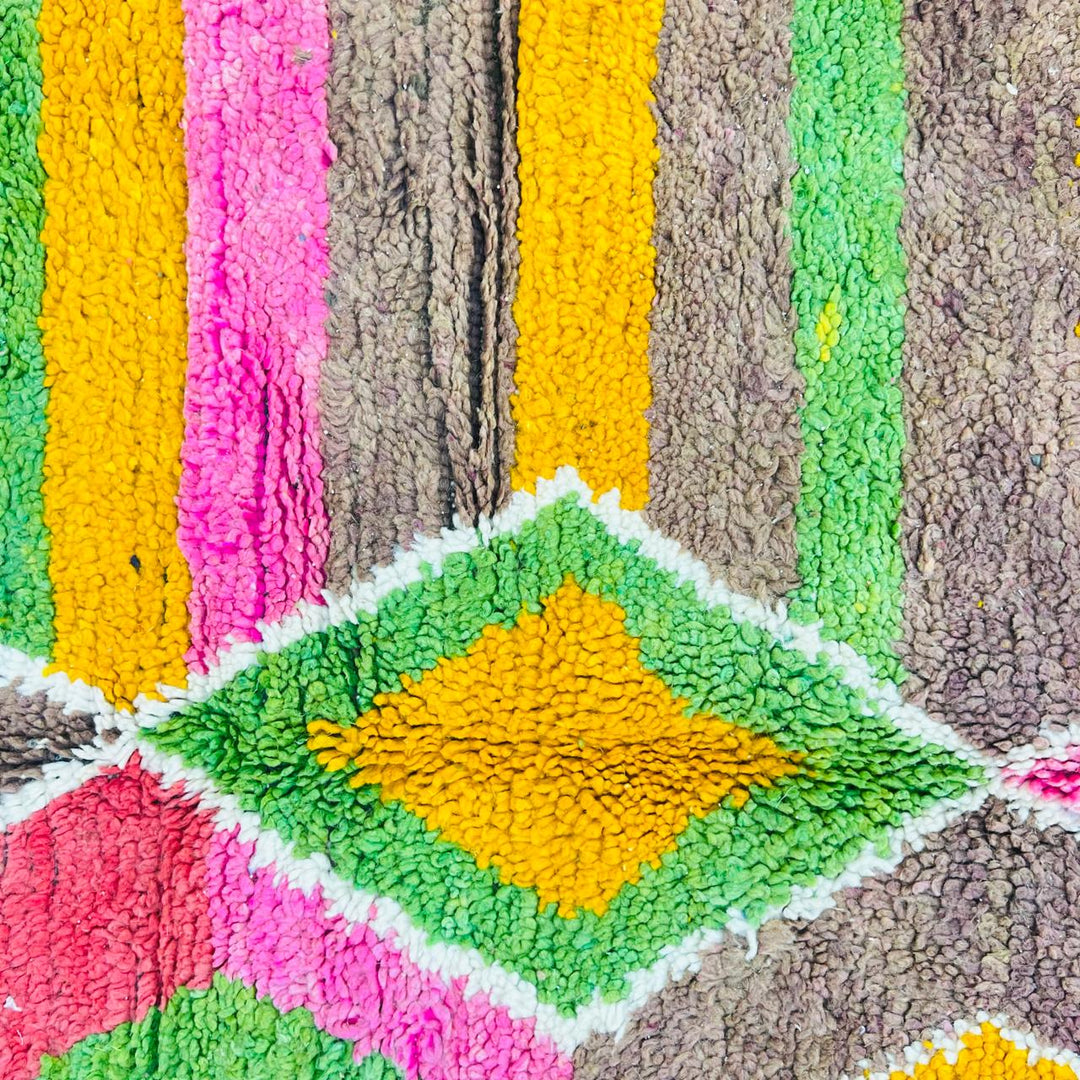 Vintage Moroccan wool rug with colorful Berber diamond and stripe patterns in pink, green and mustard