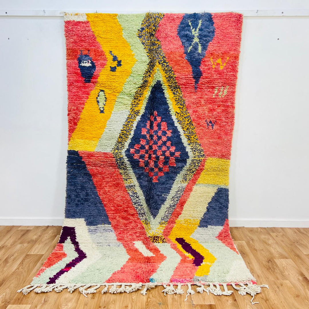 Vintage Moroccan wool rug with abstract Berber geometric design in coral pink, mustard yellow, navy and cream, handmade in Morocco