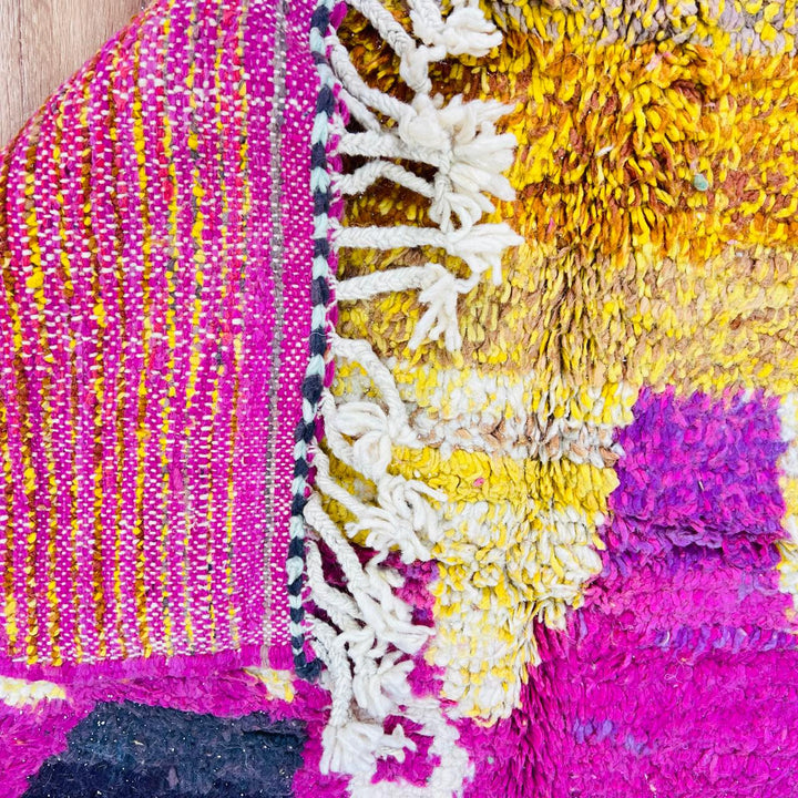 Handmade vintage Moroccan wool rug in pink and yellow with abstract Berber design. One-of-a-kind artisan rug, 255×166 cm.