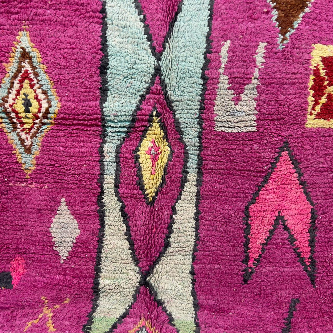 vintage moroccan wool rug with pink background and berber tribal symbols handmade shag rug