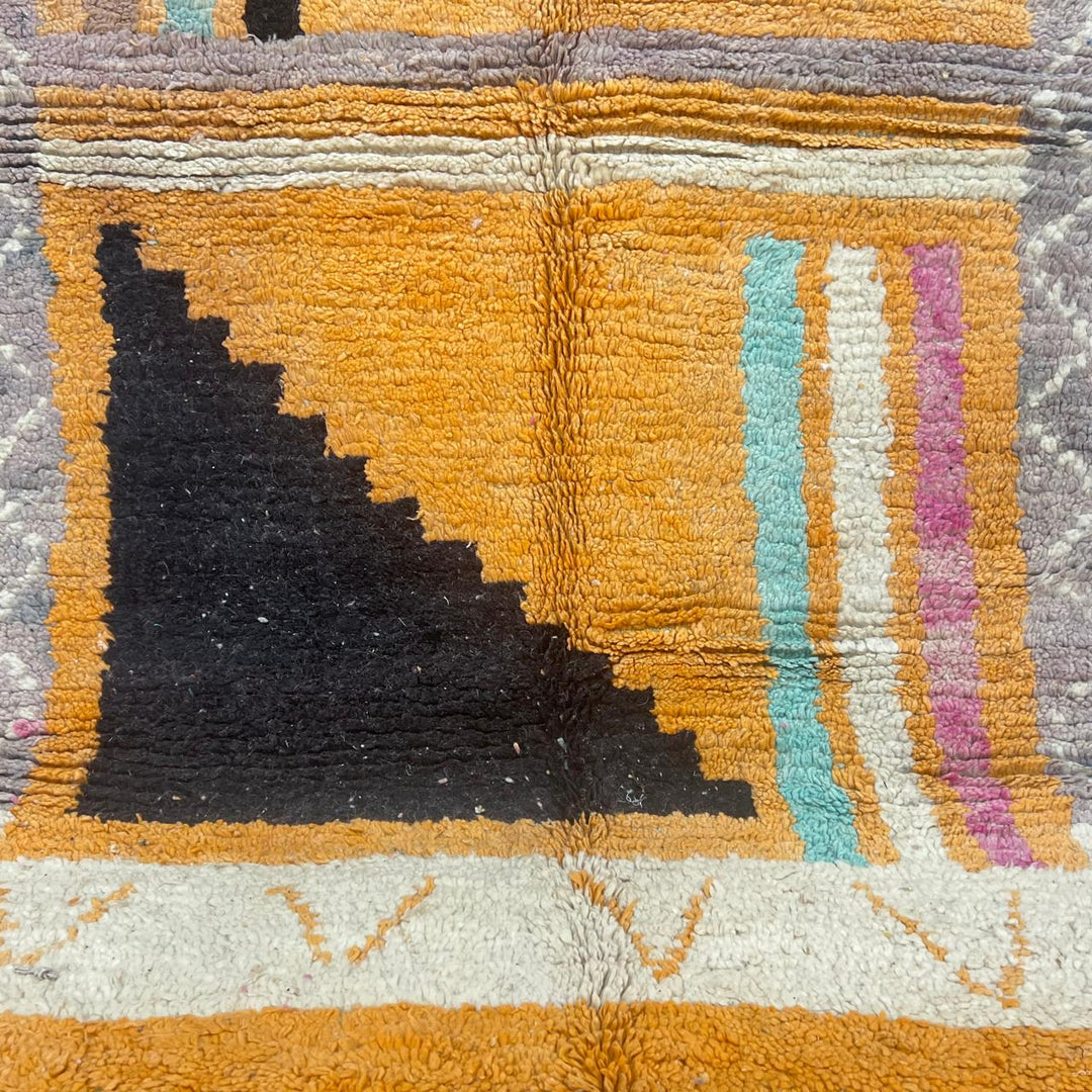 Vintage Moroccan wool rug with yellow base and blue, black Berber geometric patterns, handmade in Morocco.