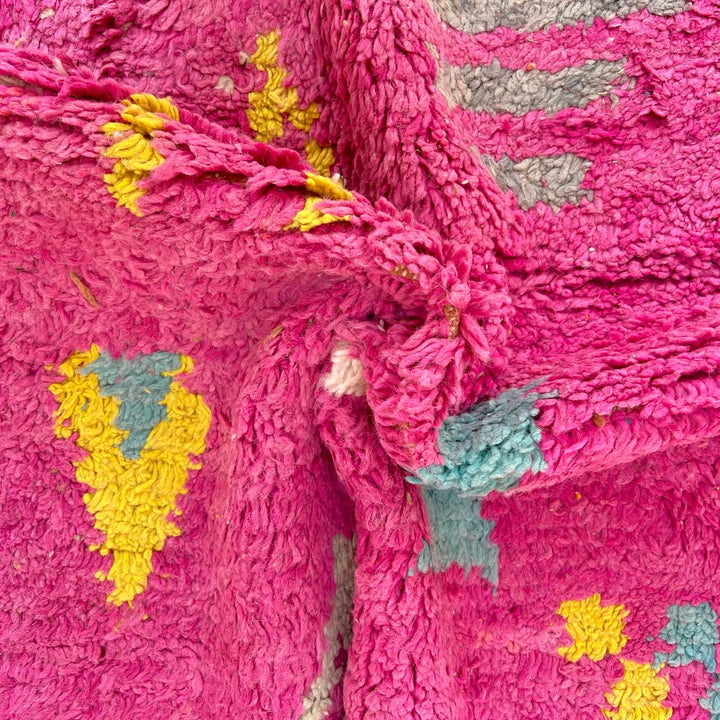 Vintage Moroccan wool rug in pink and yellow tones with abstract Berber geometric patterns, handmade in Morocco