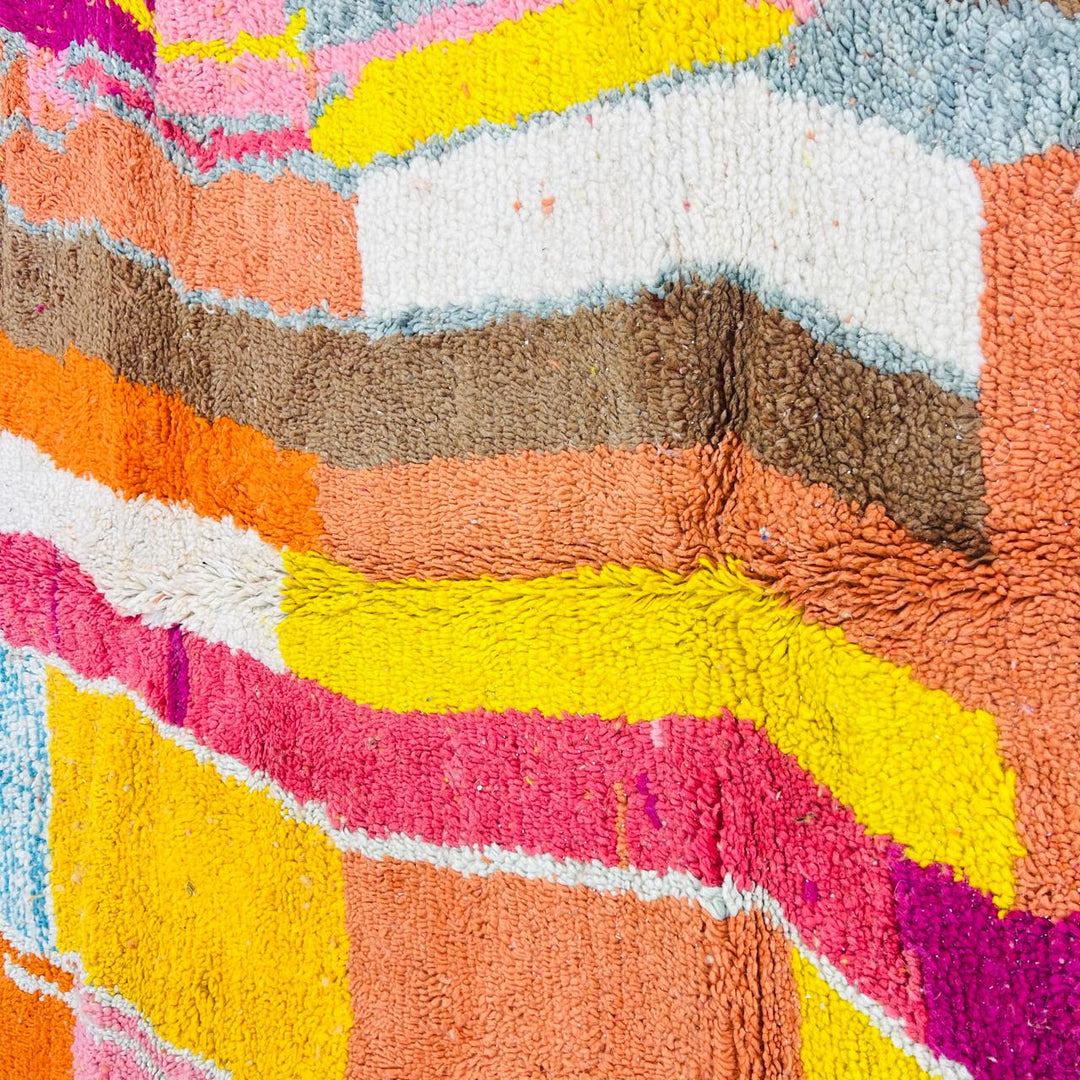 Vintage Moroccan wool rug with colorful abstract Berber pattern in yellow, pink, blue, and orange tones, handmade in Morocco