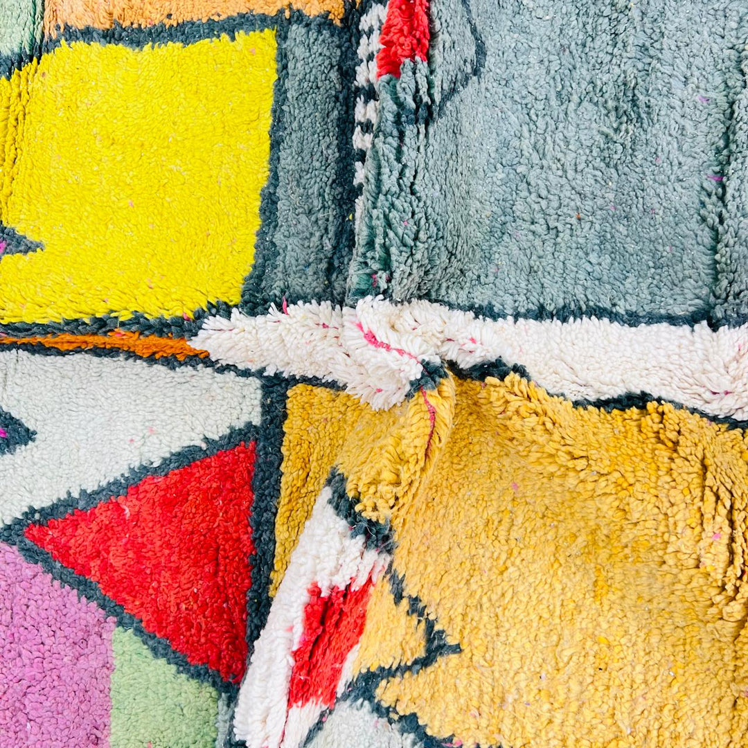 Vintage Moroccan wool rug with colorful geometric Berber pattern in pink yellow green and cream – handmade in Morocco