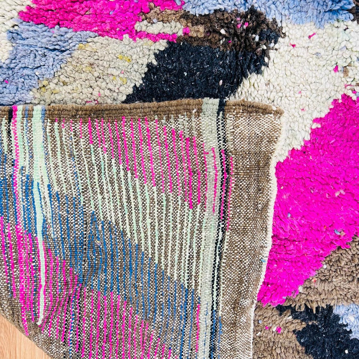 Vintage Moroccan wool rug with abstract Berber geometric pattern in pink, ivory, blue, and black