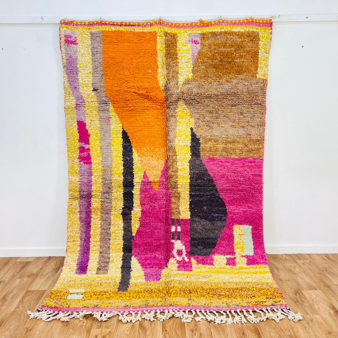 Handmade vintage Moroccan wool rug in pink and yellow with abstract Berber design. One-of-a-kind artisan rug, 255×166 cm.