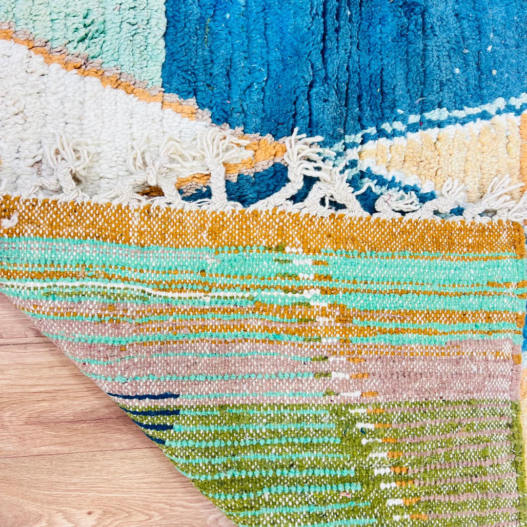Vintage Moroccan wool rug with pink background and colorful Berber geometric symbols, handmade in Morocco