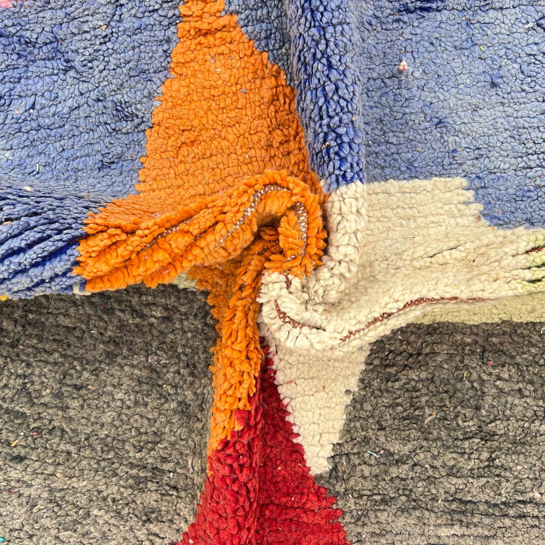Vintage Moroccan wool rug with bold geometric Berber patterns in turquoise, red, and mustard