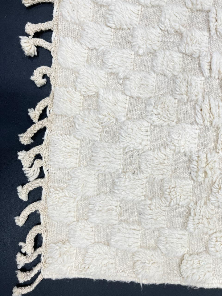 Handmade white Moroccan wool runner rug with subtle checkerboard pattern and fringe edges