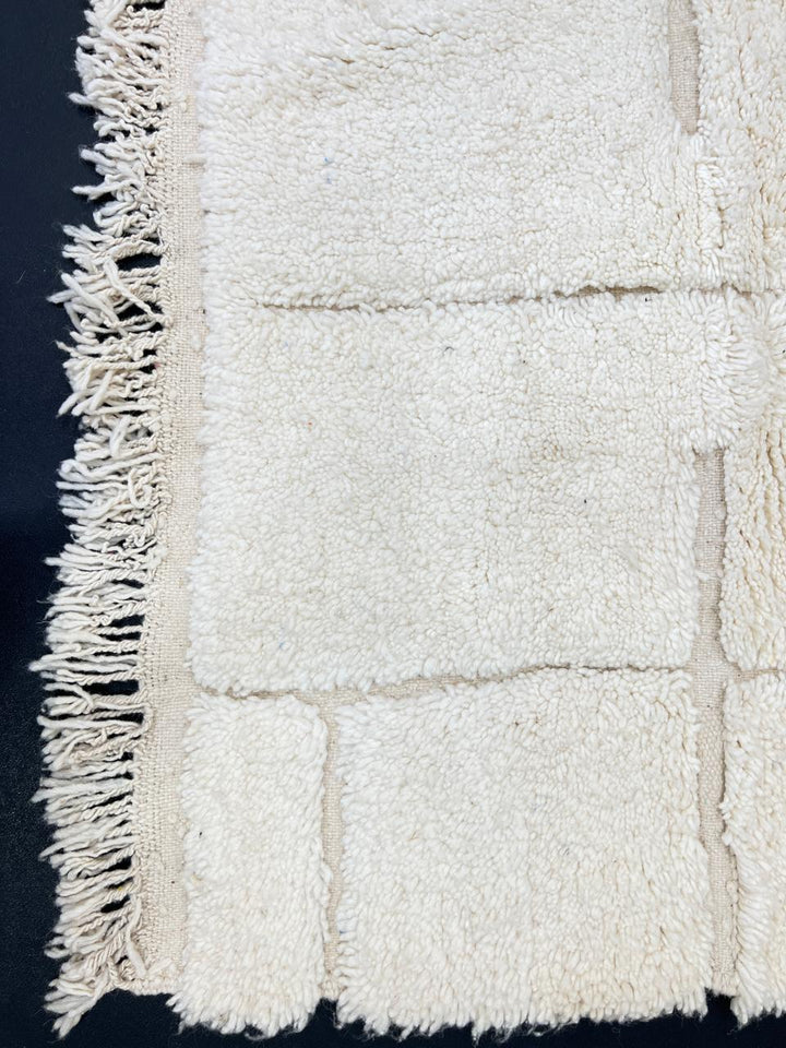 Handmade white minimalist Moroccan runner rug with subtle geometric carved design.