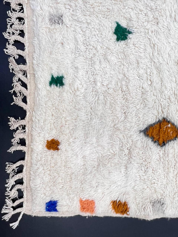 White Moroccan runner rug handmade from wool with colorful Berber symbols