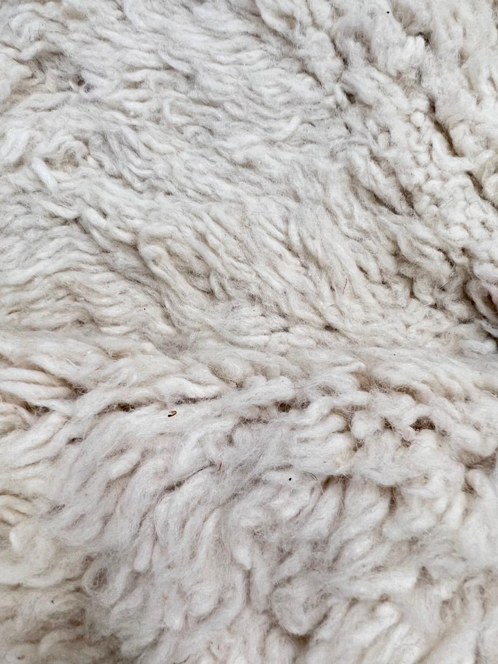 White Moroccan runner rug handmade from wool with colorful Berber symbols