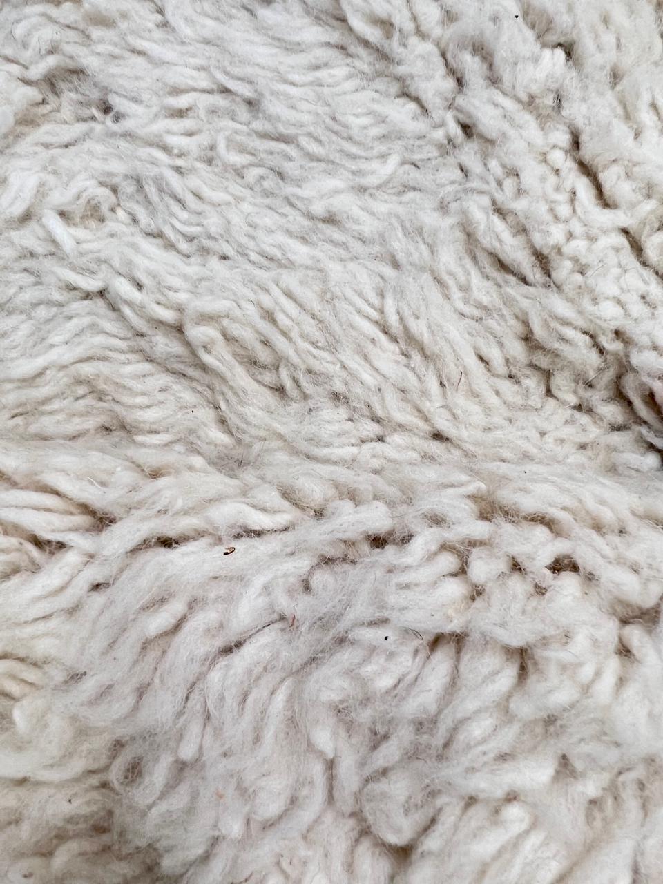 White Moroccan runner rug handmade from wool with colorful Berber symbols