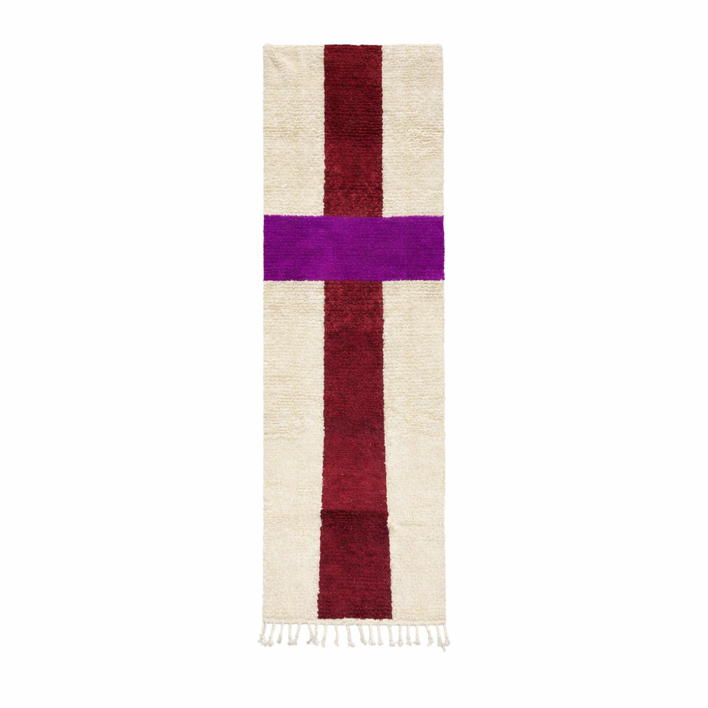 White Moroccan runner rug with a deep red vertical stripe and purple horizontal stripe, handmade from natural wool