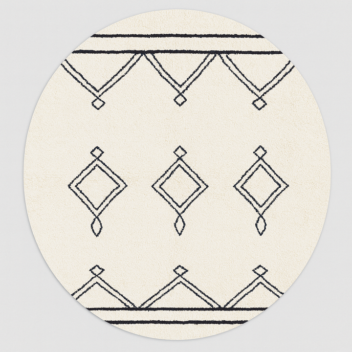 Round white Moroccan wool rug with black Berber diamond motifs in a minimalist design.