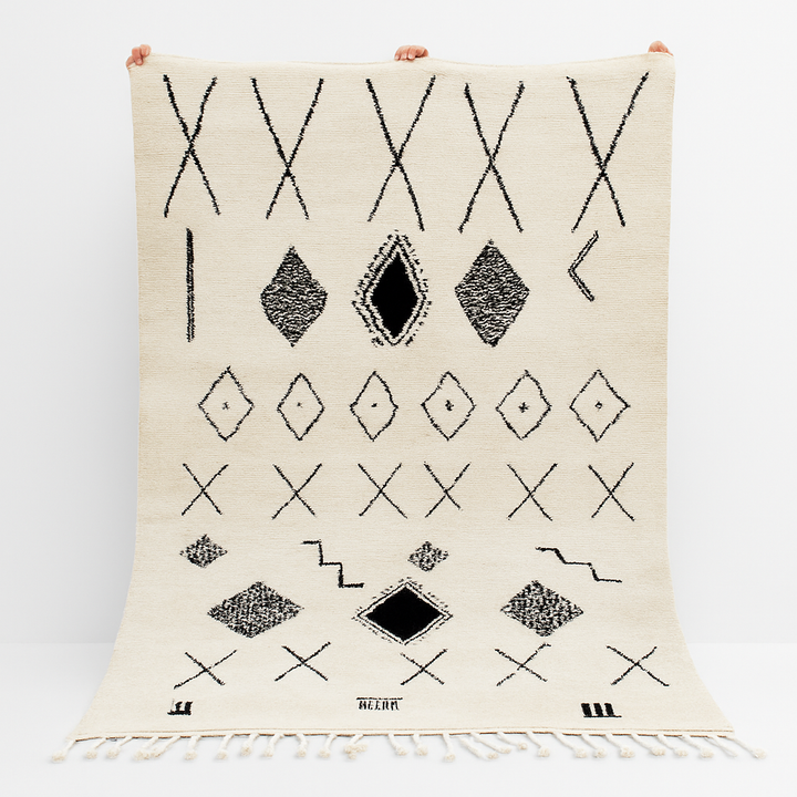 Handmade white Moroccan wool rug with black geometric motifs – Beni Ourain design