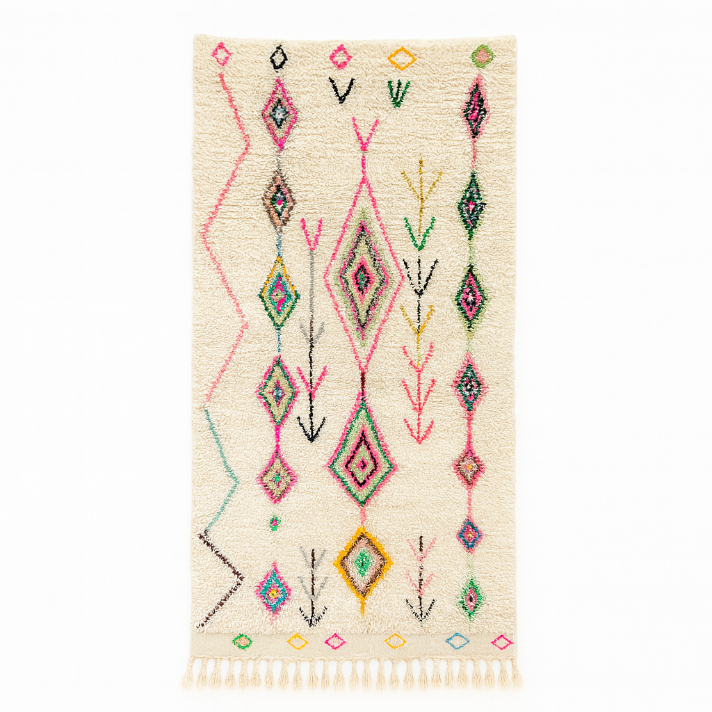 Handmade white Moroccan wool runner rug with colorful Berber diamond motifs in pink, green, yellow, turquoise, and black