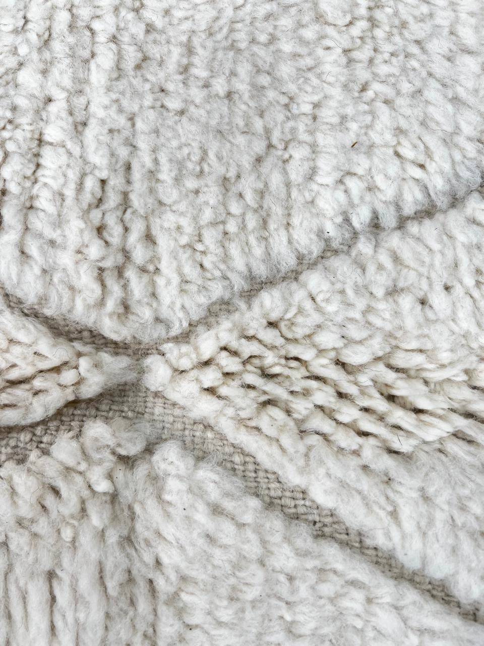 Handmade white Moroccan wool runner rug with minimalist geometric carved pattern