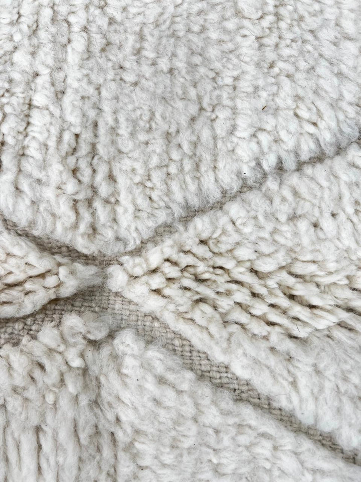 Handmade white Moroccan wool runner rug with minimalist geometric carved pattern