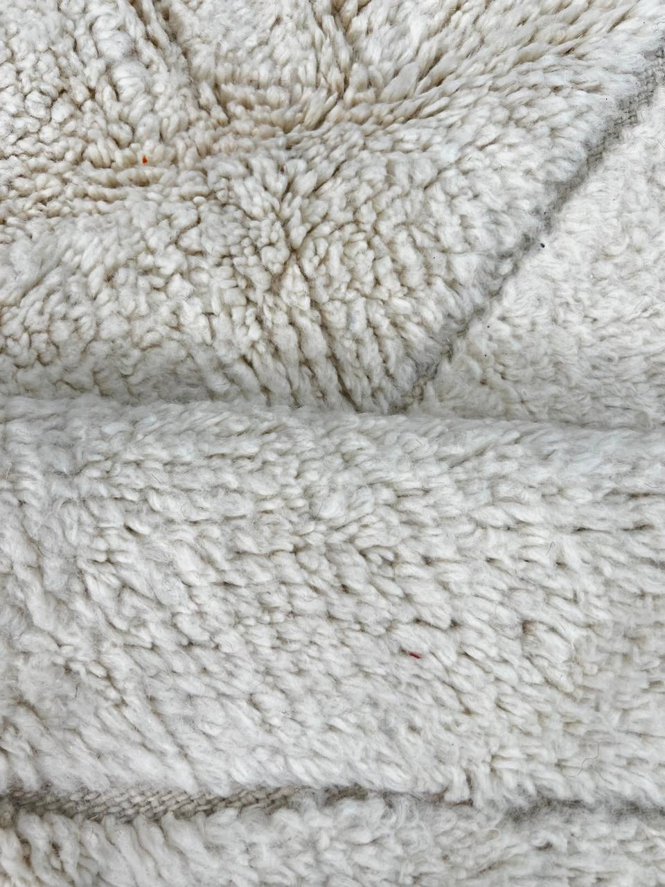 Handmade white Moroccan wool runner rug with minimalist geometric carved pattern