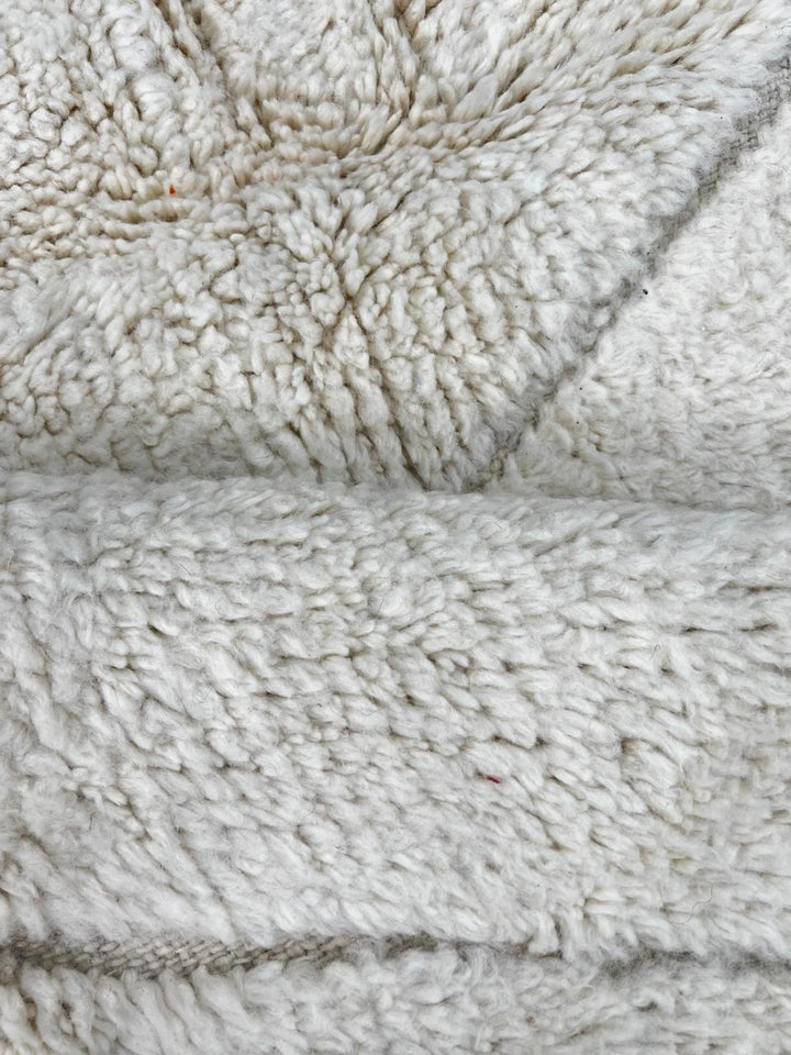 Handmade white Moroccan wool runner rug with minimalist geometric carved pattern