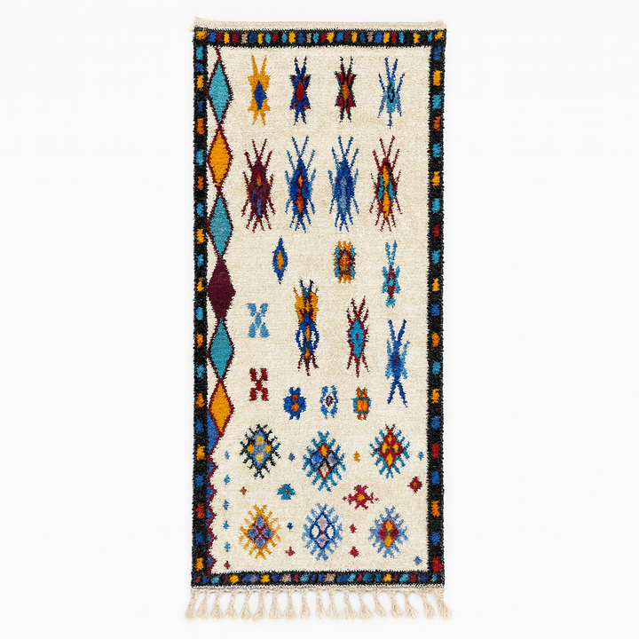 Handmade white Moroccan wool runner rug with colorful tribal Berber motifs in blue, red, yellow, turquoise, and orange