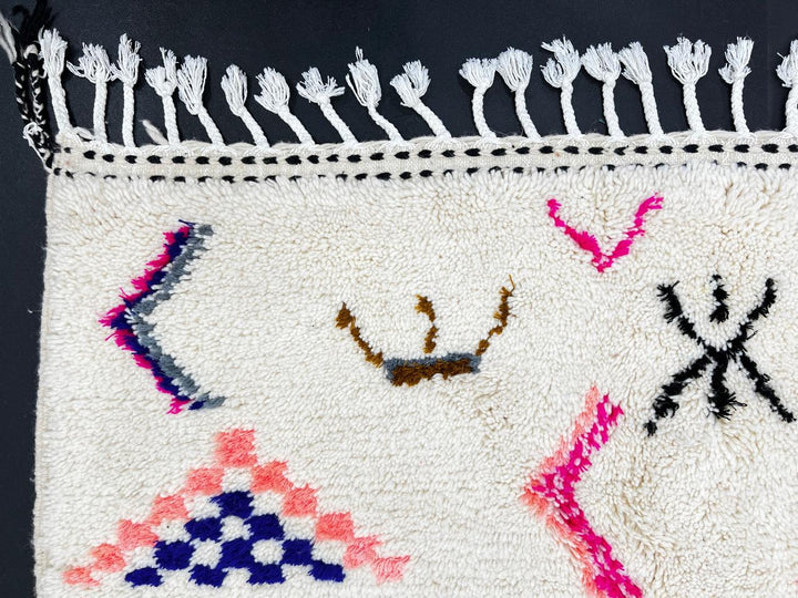 Handmade white Moroccan wool runner rug with colorful Berber symbols and modern geometric motifs