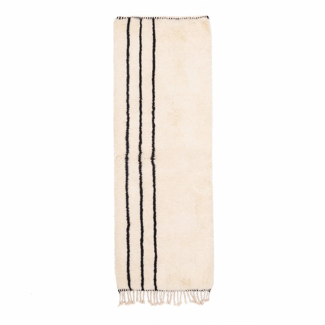 Beige towel with black stripes and fringes on a white background