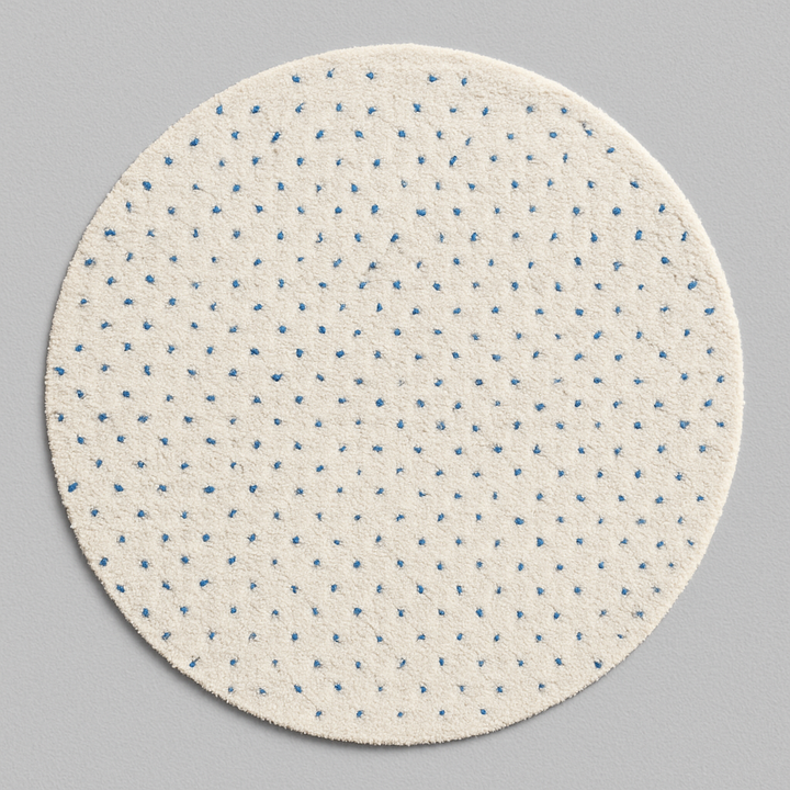 Round white Moroccan rug with small blue dotted pattern, handmade wool design