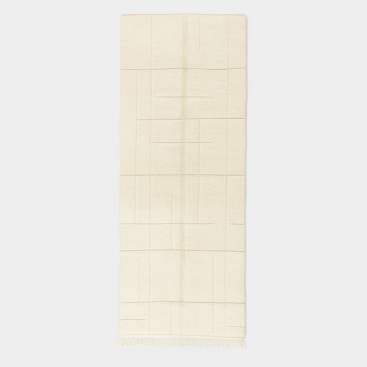 Handmade white minimalist Moroccan runner rug with subtle geometric carved design.